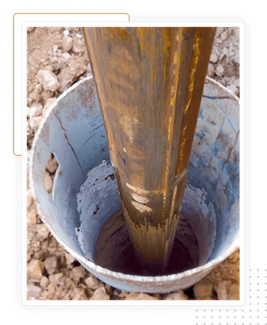 A bucket of oil is pouring into the ground.