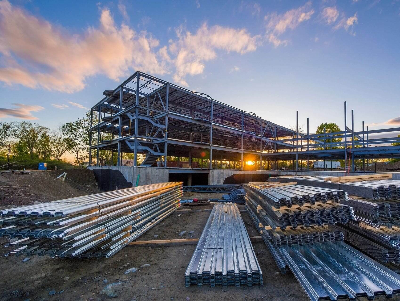 A building under construction with many metal pipes.