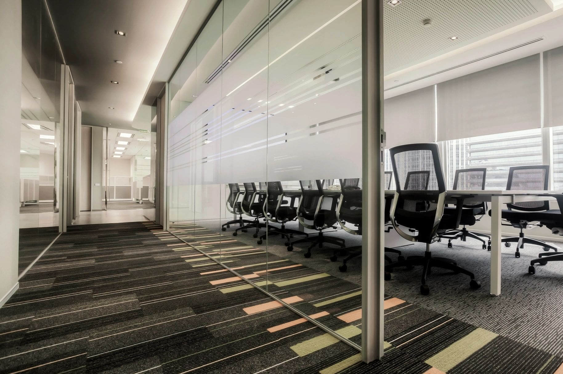 A room with many chairs and glass walls