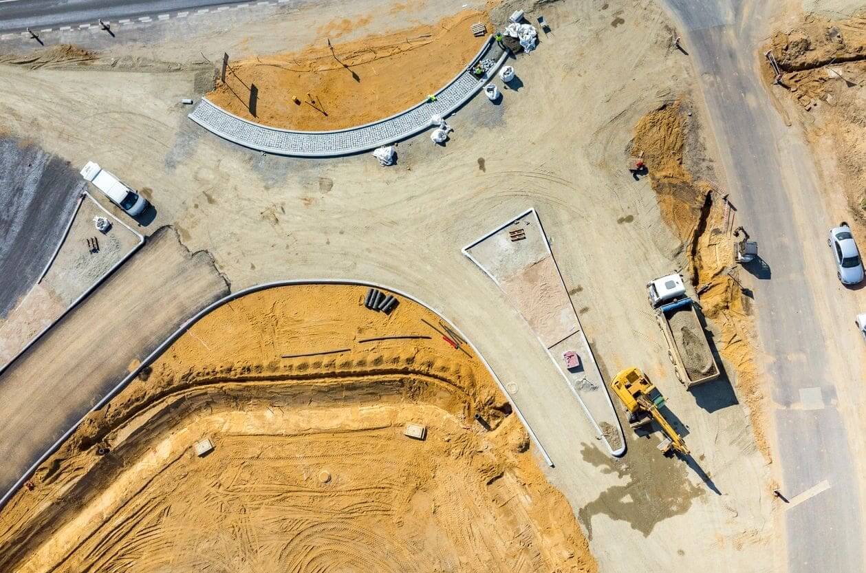 A construction site with several large trucks and equipment.